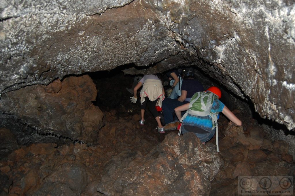 Photo of a group squatting in a cave