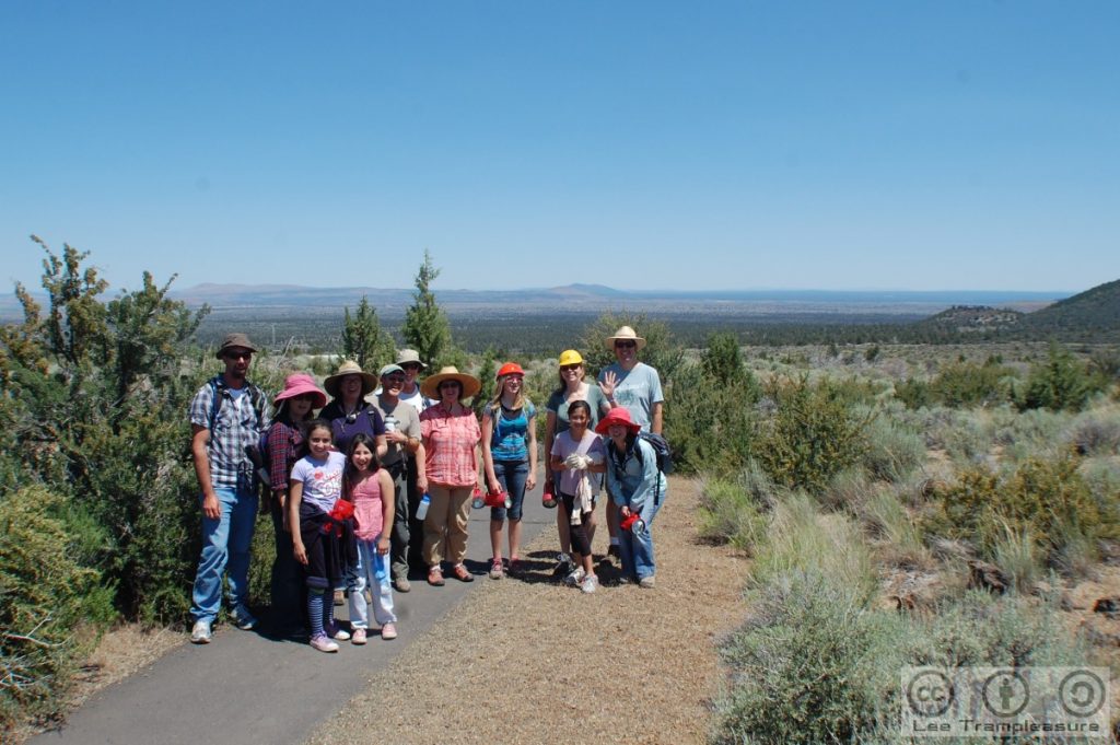Photo showing a group of people with the flat NE California in the background