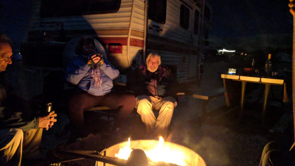 photo of people around a campfire